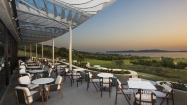 Costa Navarino Bay Course clubhouse at sunset